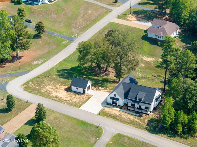 an aerial view of a house with yard swimming pool and outdoor seating