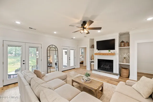 a living room with furniture a fireplace and a flat screen tv