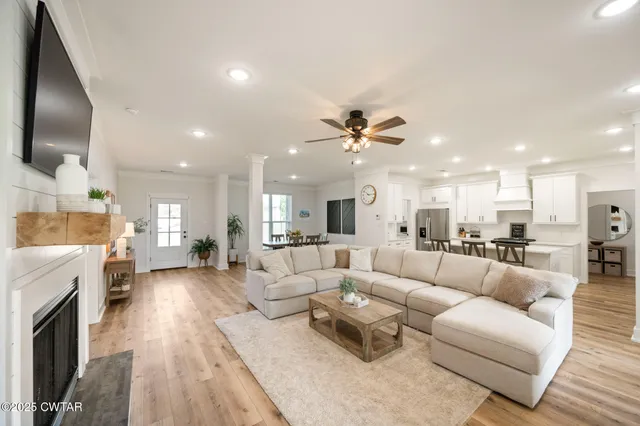 a living room with furniture and a fireplace