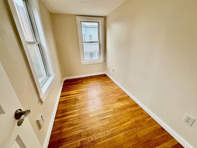 a front view of a house with a parking space