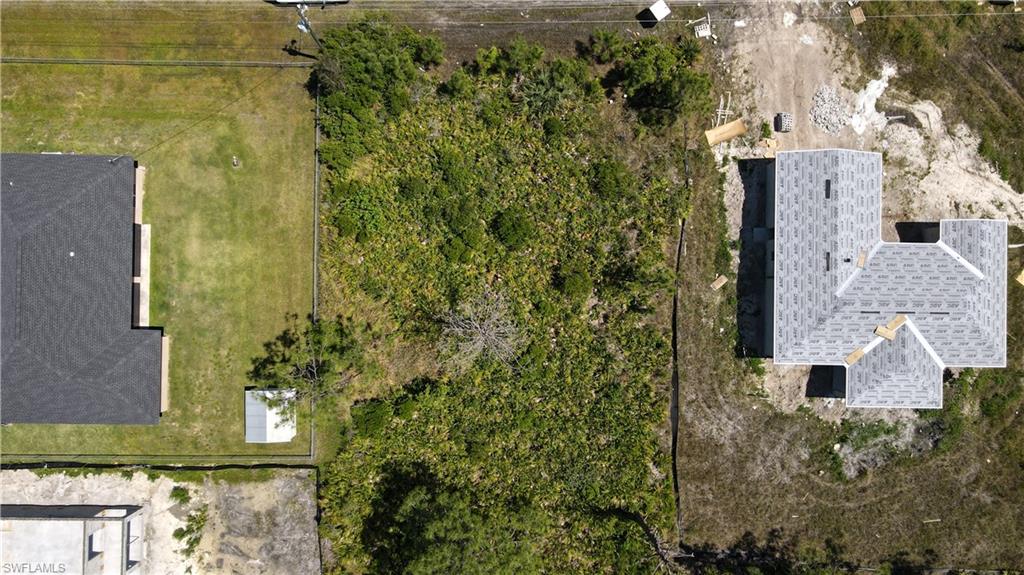aerial view of a house with a yard