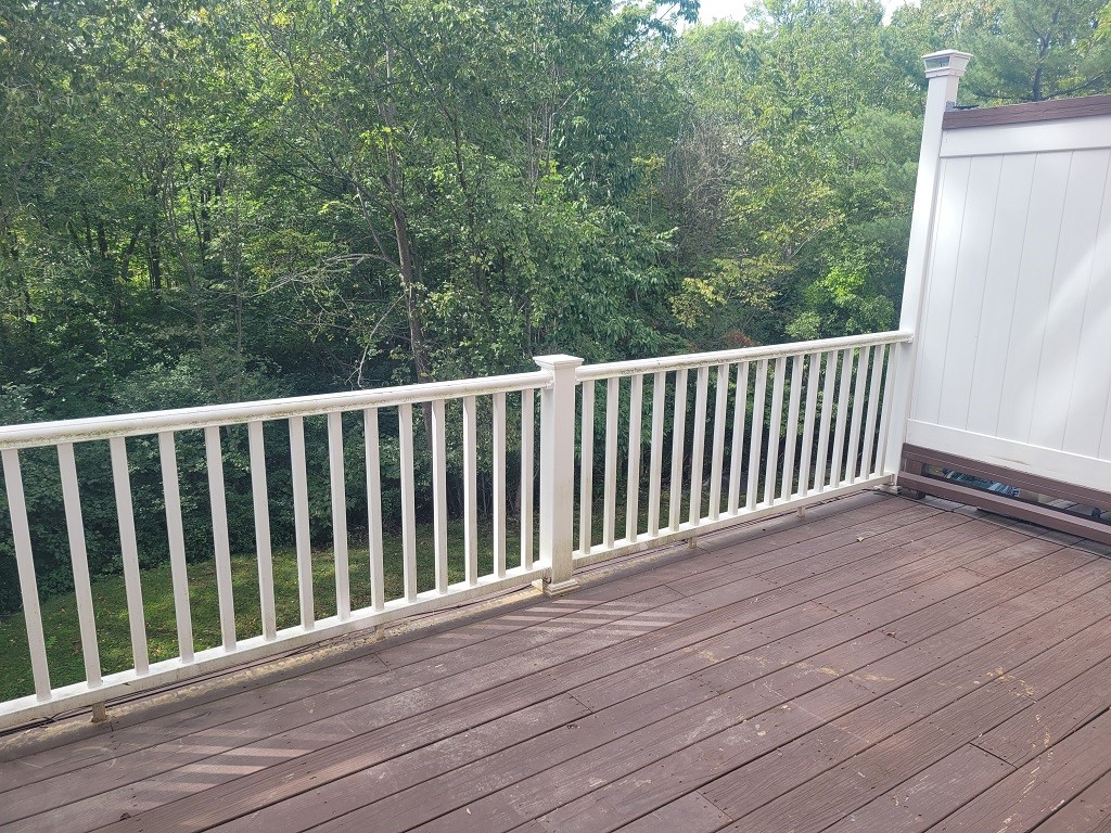 3399 Post Road, Unit 27 Warwick, RI 02886 - Photo 30 of 36 Large deck overlooking woods and view of the stream in the winter