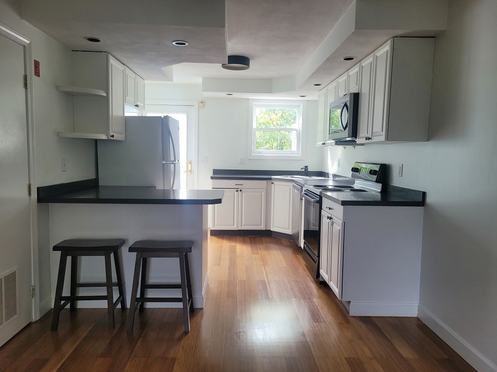 3399 Post Road, Unit 27 Warwick, RI 02886 - Photo 6 of 36 Great space to cook while enjoying the treed view