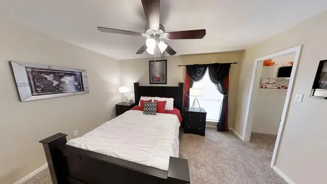a bedroom with a bed and a chandelier
