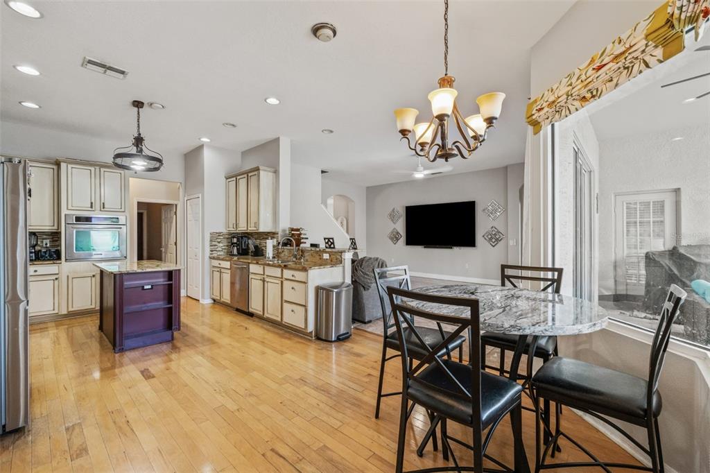 22623 Cliffside Way Land O' Lakes, FL 34639 - Photo 12 of 49 a view of a dining room with furniture and wooden floor