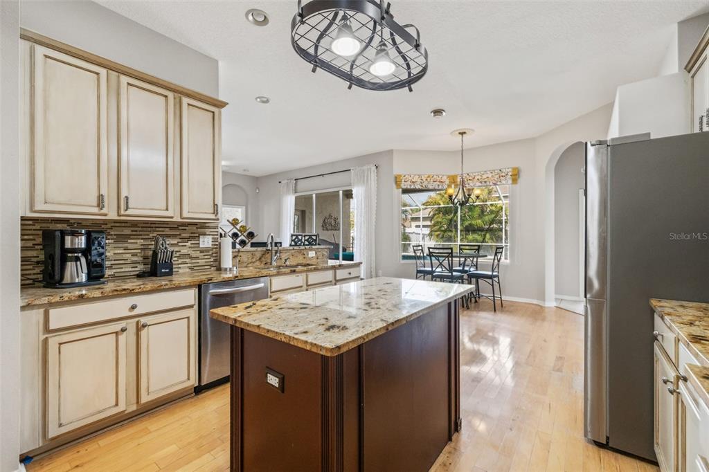 22623 Cliffside Way Land O' Lakes, FL 34639 - Photo 17 of 49 a kitchen with stainless steel appliances granite countertop a stove and a refrigerator