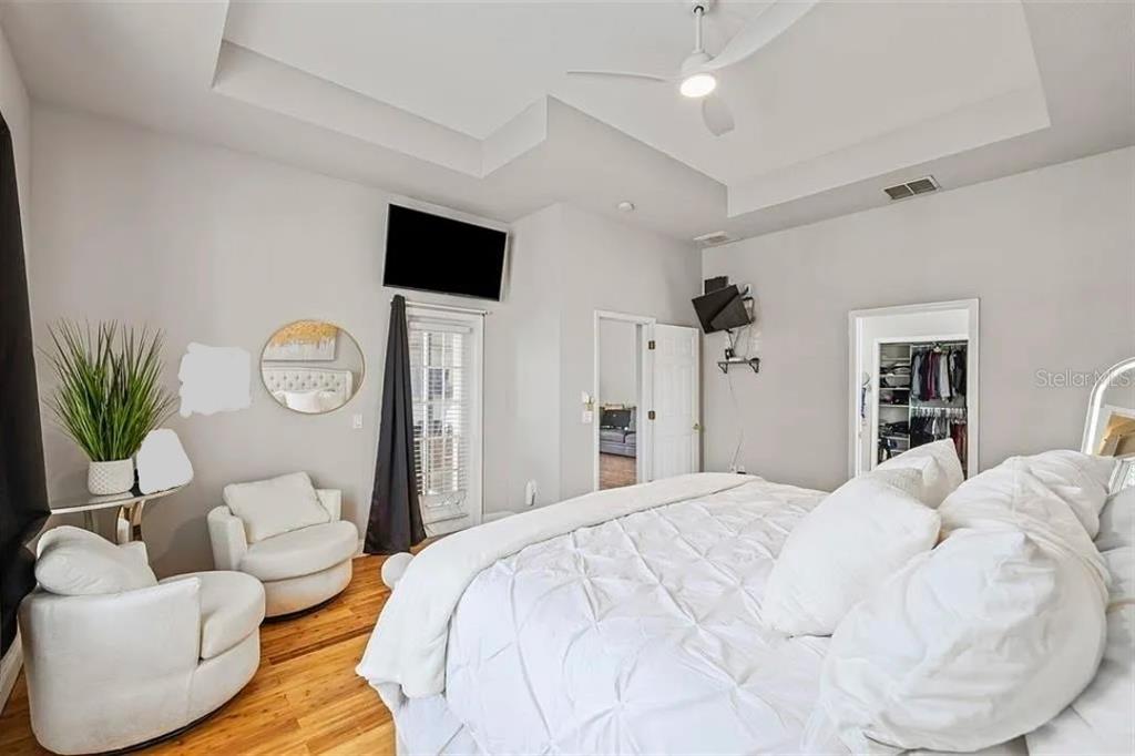 22623 Cliffside Way Land O' Lakes, FL 34639 - Photo 27 of 49 a bedroom with a bed a couch and a potted plant