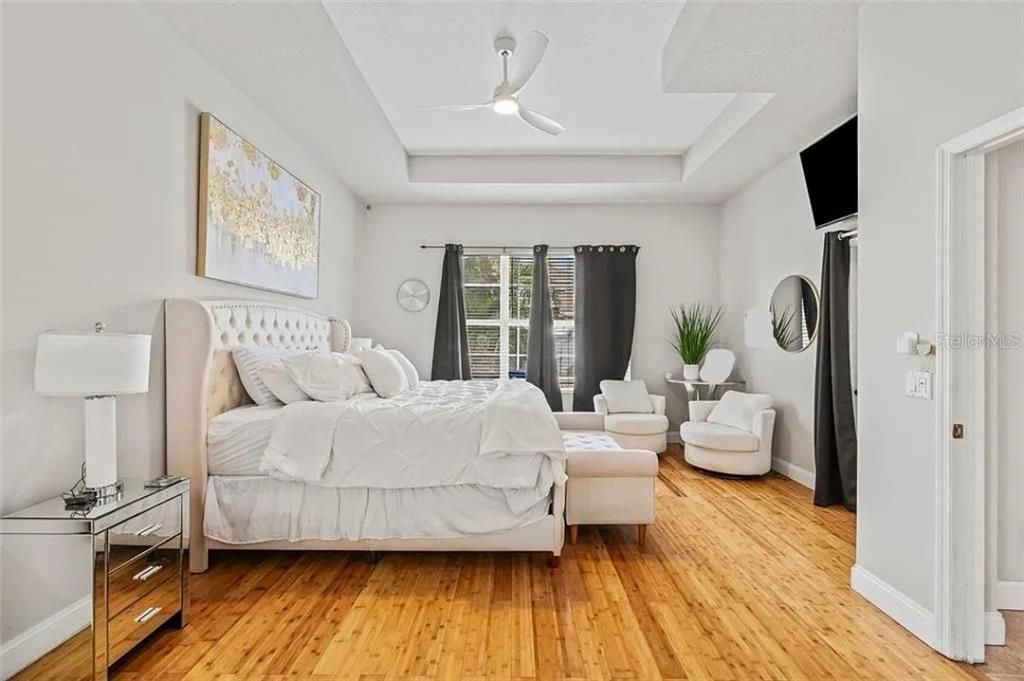 22623 Cliffside Way Land O' Lakes, FL 34639 - Photo 28 of 49 a bedroom with a bed and wooden floor