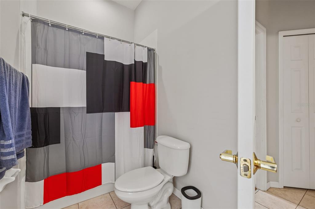 22623 Cliffside Way Land O' Lakes, FL 34639 - Photo 37 of 49 a white toilet sitting next to a bathroom sink and a shower