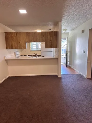 a view of kitchen with refrigerator stove microwave and cabinets