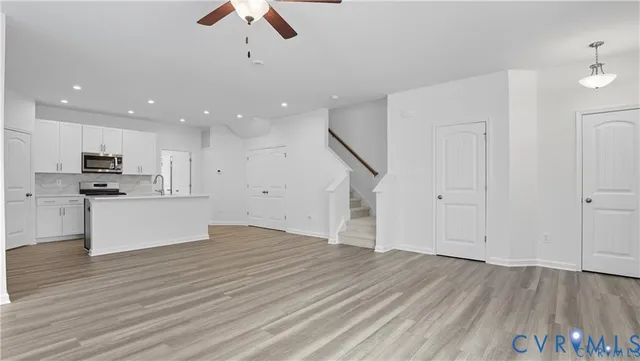 a view of kitchen with granite countertop cabinets and wooden floor
