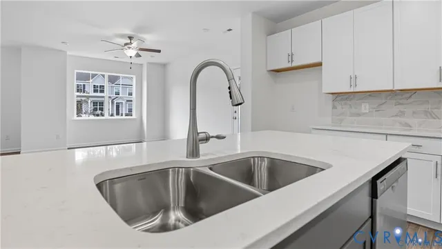 a close view of a sink a faucet and appliance in the kitchen