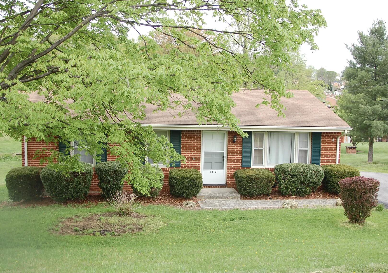 1612 Mountain View Road Vinton, VA 24179 - Photo 1 of 1 a front view of a house with a garden