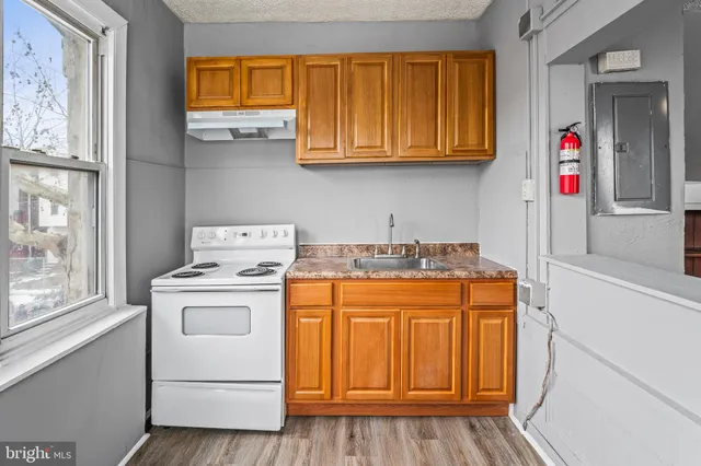 a utility room with fridge and washer
