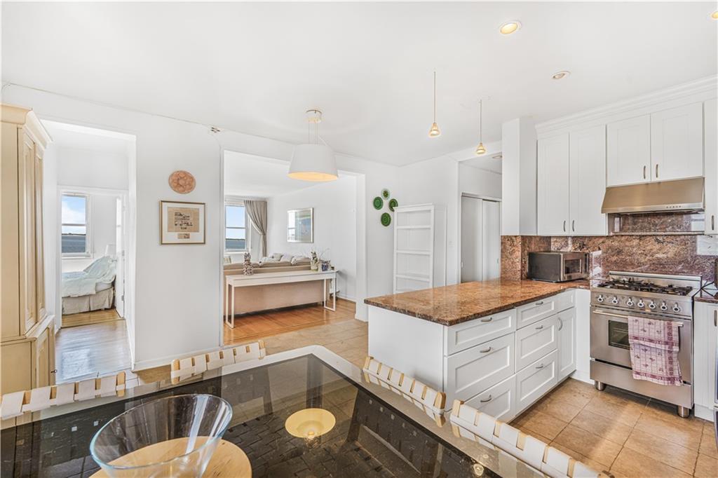 286 Corbin Place, Unit 5E Brooklyn, NY 11235 - Photo 11 of 35 a spacious kitchen with stainless steel appliances granite countertop a sink and cabinets