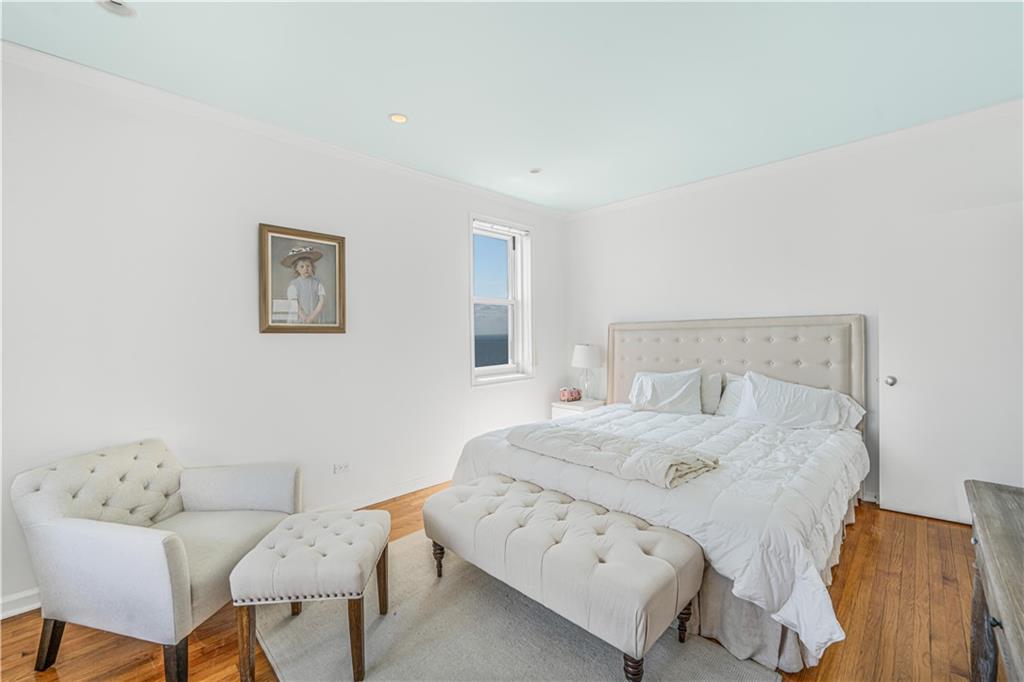 286 Corbin Place, Unit 5E Brooklyn, NY 11235 - Photo 14 of 35 a bedroom with a bed and a couch