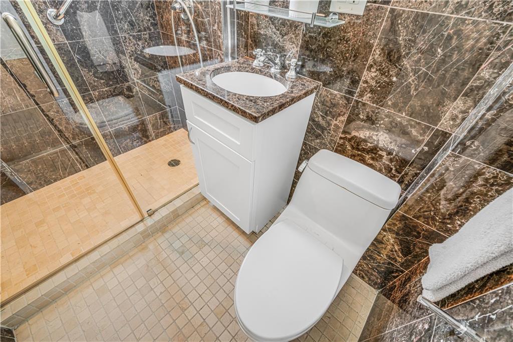 286 Corbin Place, Unit 5E Brooklyn, NY 11235 - Photo 17 of 35 a bathroom with a sink and a mirror