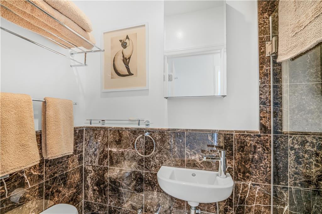 286 Corbin Place, Unit 5E Brooklyn, NY 11235 - Photo 26 of 35 a bathroom with a sink mirror and vanity