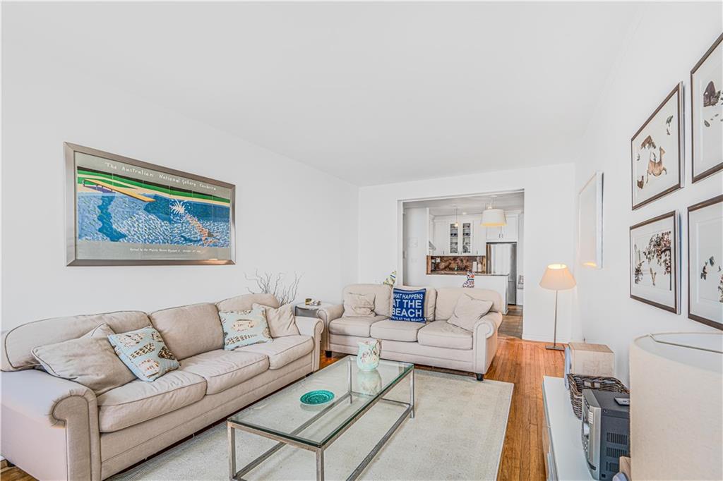 286 Corbin Place, Unit 5E Brooklyn, NY 11235 - Photo 4 of 35 a living room with furniture and a painting on the wall