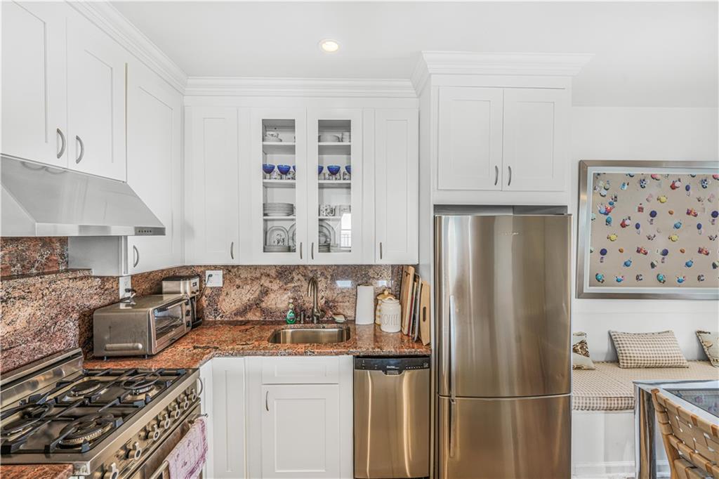 286 Corbin Place, Unit 5E Brooklyn, NY 11235 - Photo 9 of 35 a kitchen with stainless steel appliances granite countertop a refrigerator and a stove