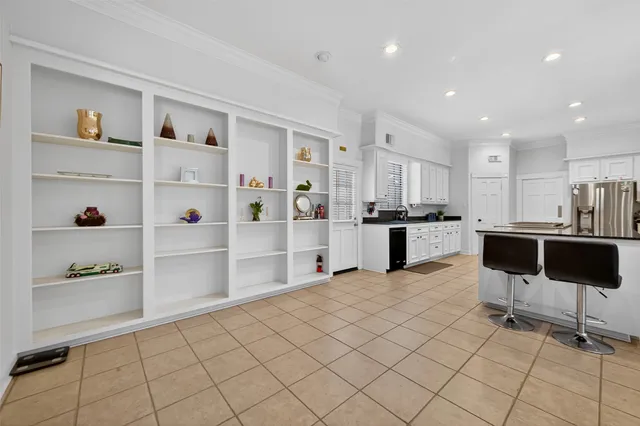 a kitchen with a refrigerator and white cabinets