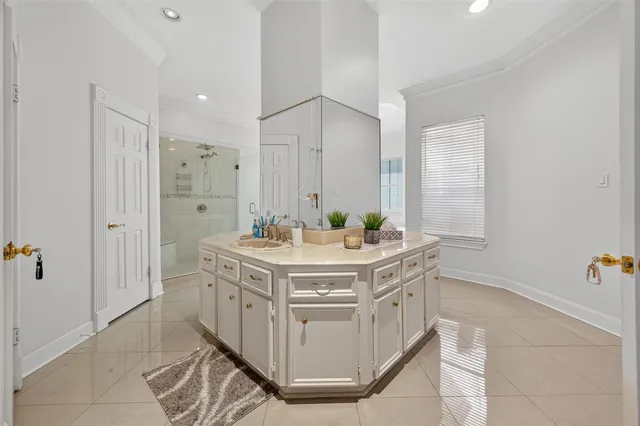 a bathroom with a granite countertop sink a mirror and a shower