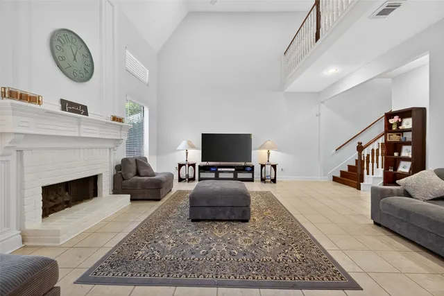 a living room with furniture a rug and a fireplace