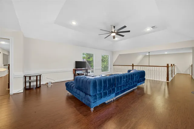 a living room with furniture ceiling fan and a rug