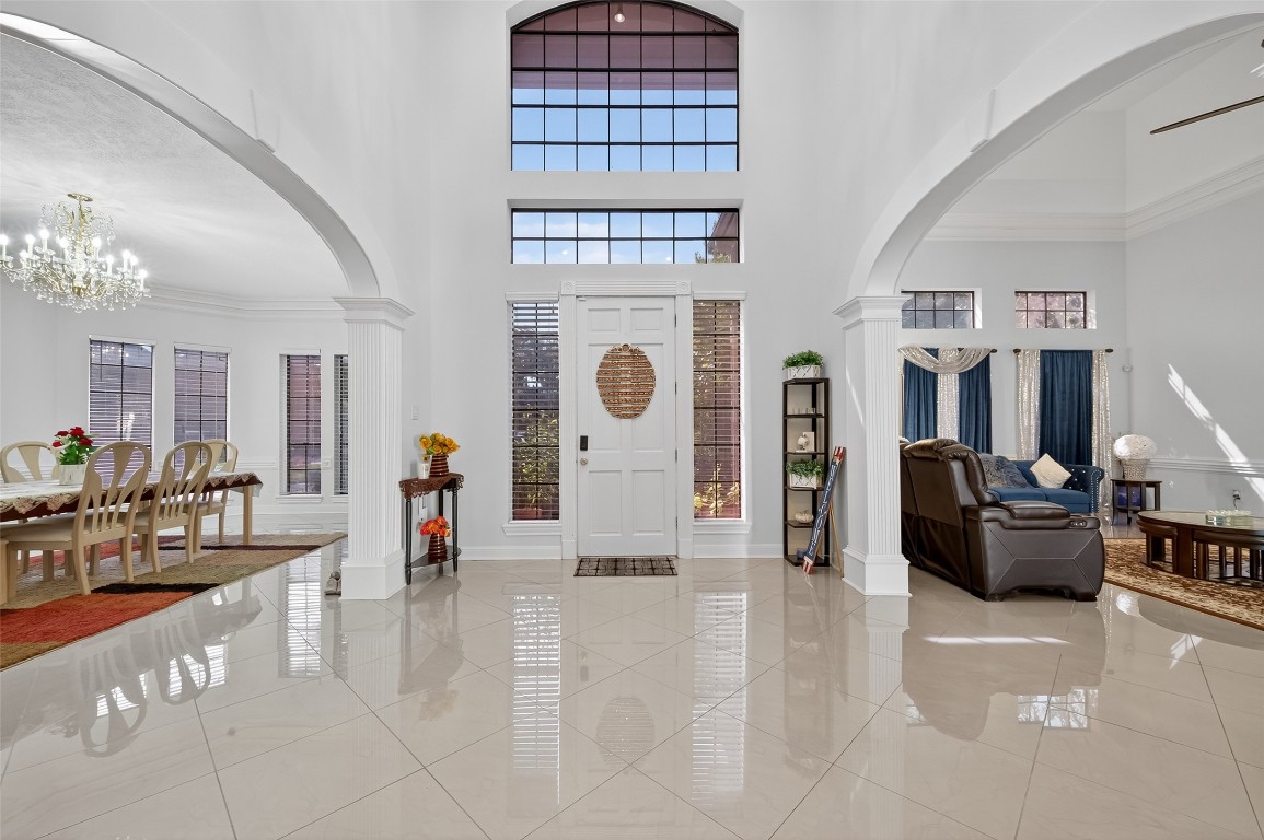 17318 Rothko Lane Spring, TX 77379 - Photo 3 of 46 a living room with furniture a chandelier and fireplace