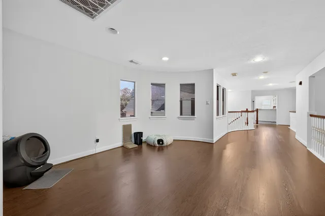 a view of a livingroom with furniture and hardwood floor