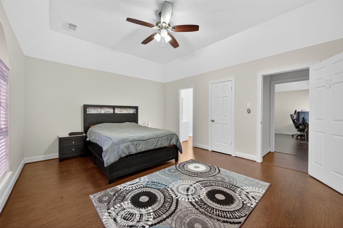 17318 Rothko Lane Spring, TX 77379 - Photo 32 of 46 a bedroom with a bed and a chandelier