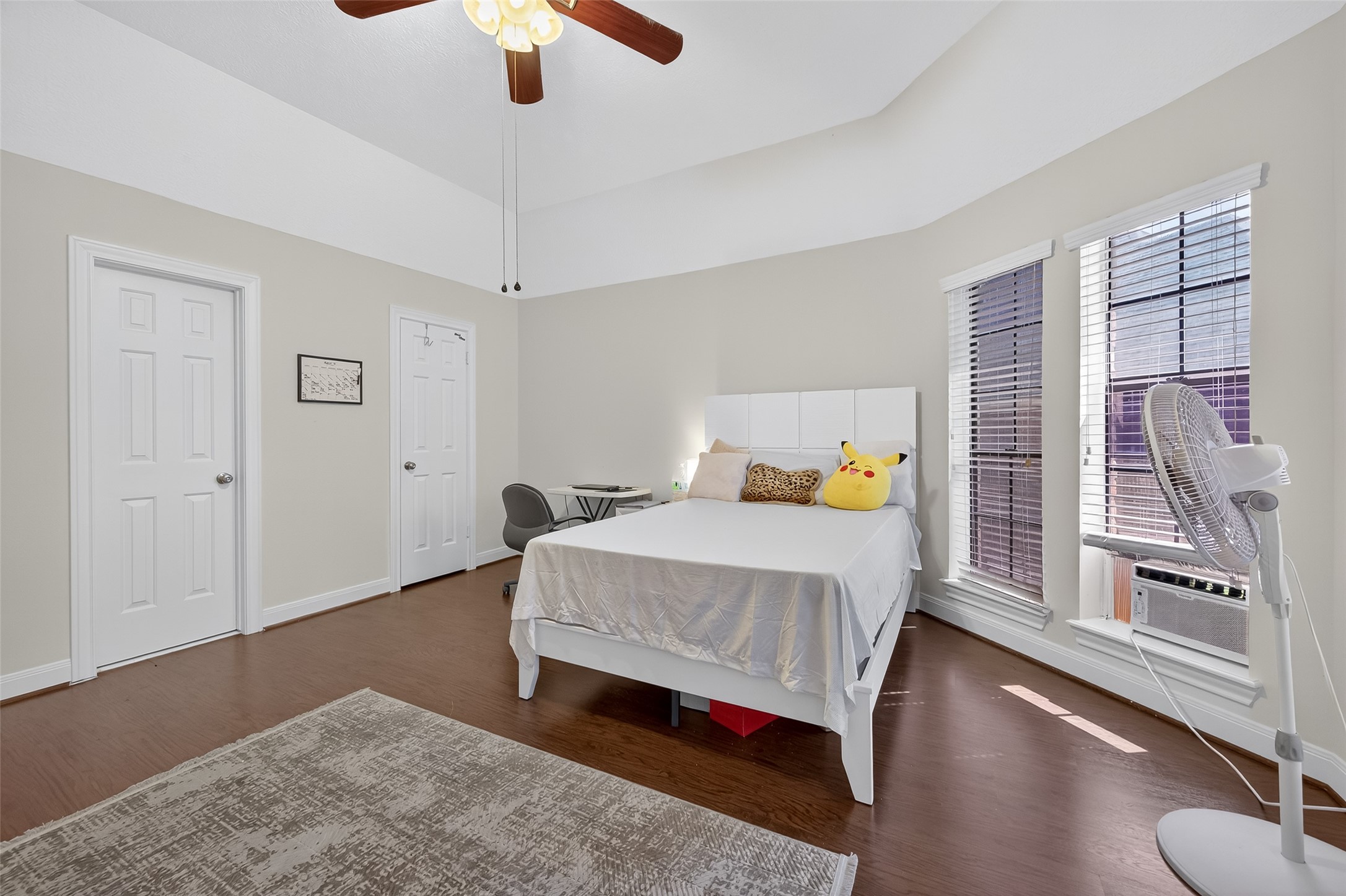 17318 Rothko Lane Spring, TX 77379 - Photo 34 of 46 a bedroom with a bed and a chandelier