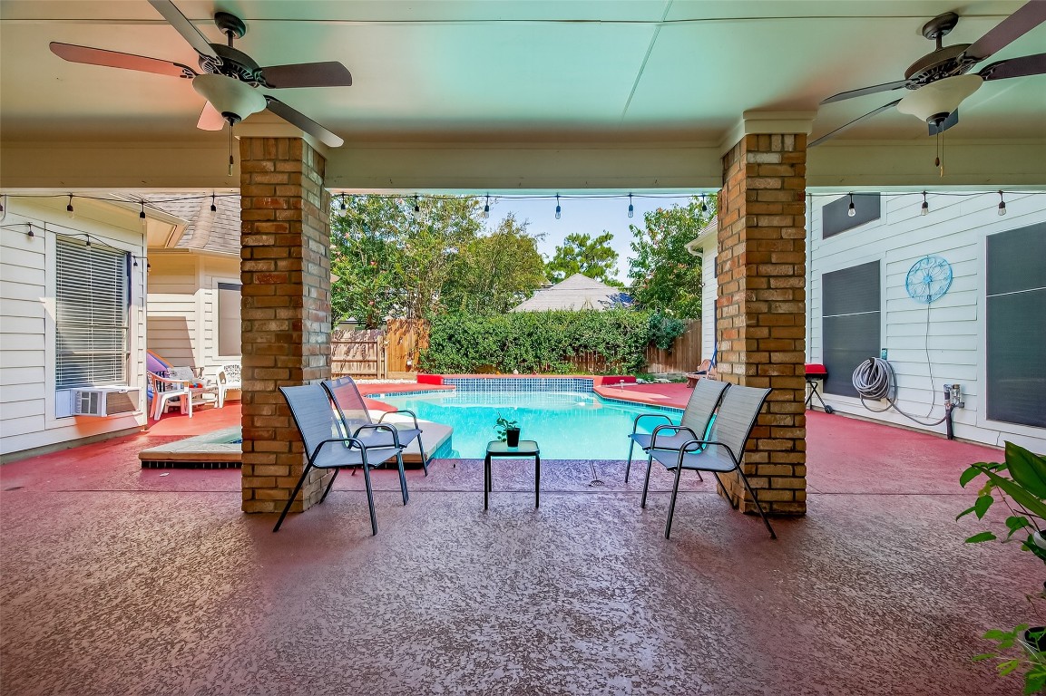 17318 Rothko Lane Spring, TX 77379 - Photo 45 of 46 a chair and table sitting in front of a building