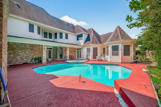 a view of a house with a yard patio and a small yard