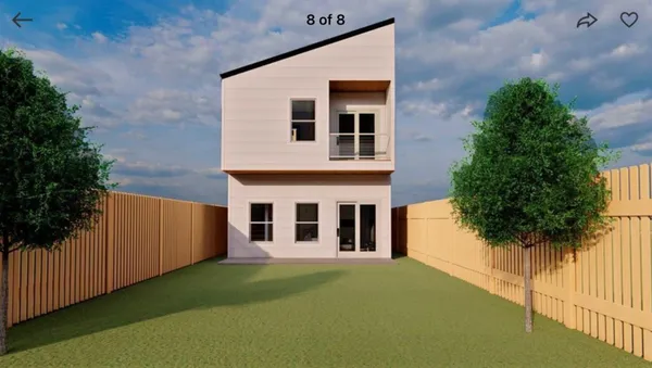 a front view of a house with plants and garden