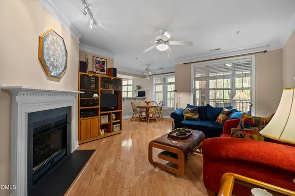 a living room with furniture a flat screen tv and a fireplace