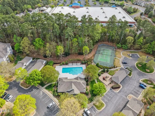 an aerial view of a house with garden space and street view