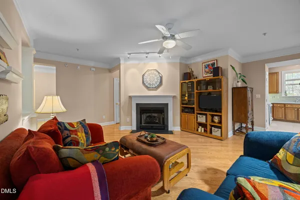 a living room with furniture a fireplace and a window