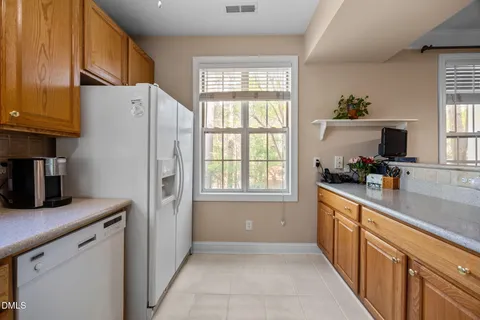a kitchen with a refrigerator and a sink