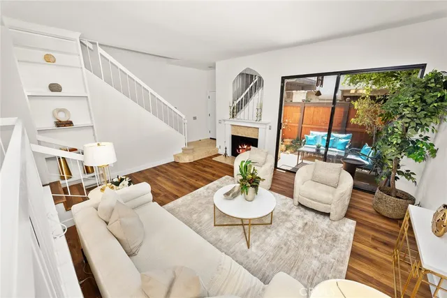 a living room with furniture fireplace and a large window