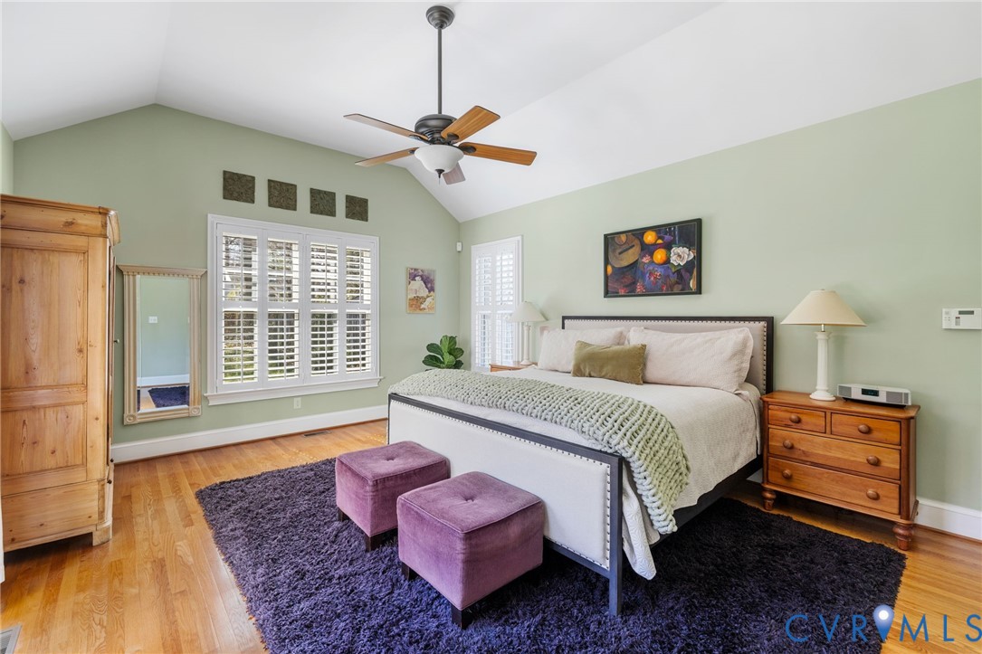 8947 Cherokee Road Richmond, VA 23235 - Photo 24 of 45 a spacious bedroom with a bed and wooden floor