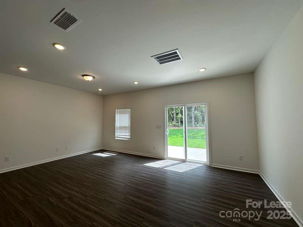 3512 Nimbell Road Monroe, NC 28110 - Photo 3 of 18 an empty room with wooden floor and windows