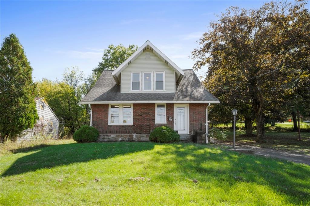 a front view of house with yard and green space