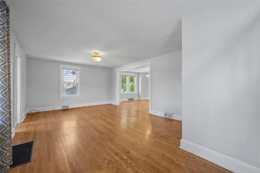 464 Franklin Street Slippery Rock, PA 16057 - Photo 12 of 45 an empty room with wooden floor and windows