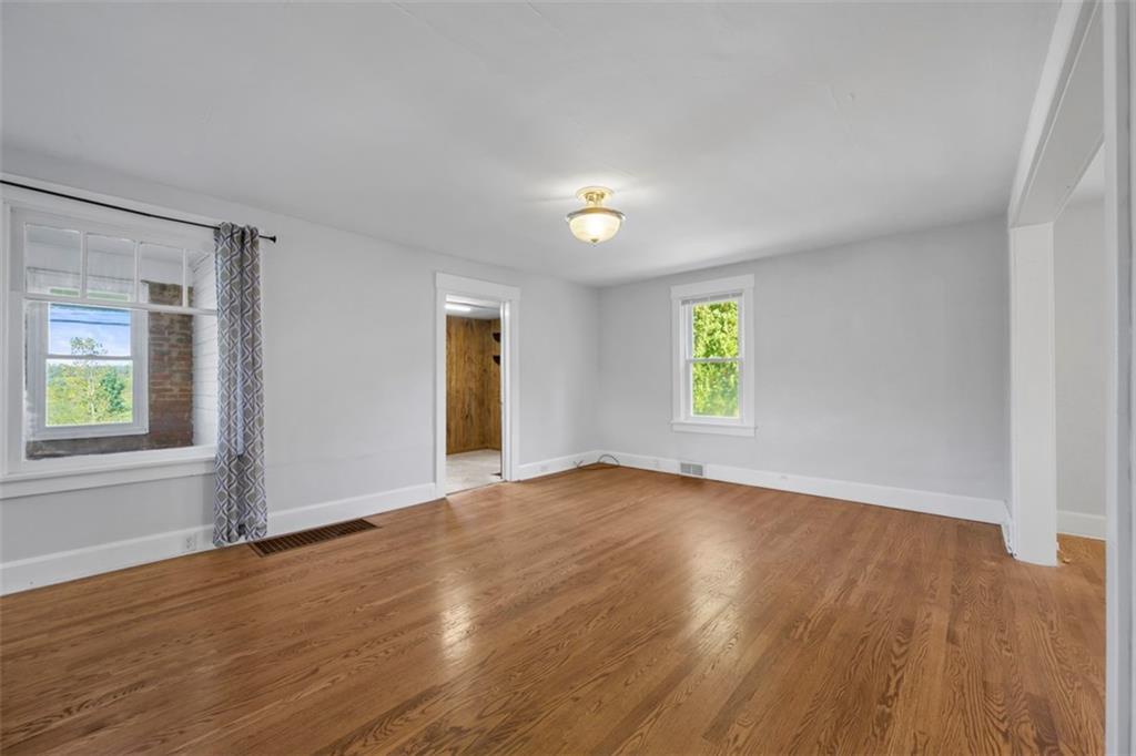 464 Franklin Street Slippery Rock, PA 16057 - Photo 14 of 45 an empty room with windows and wooden floor