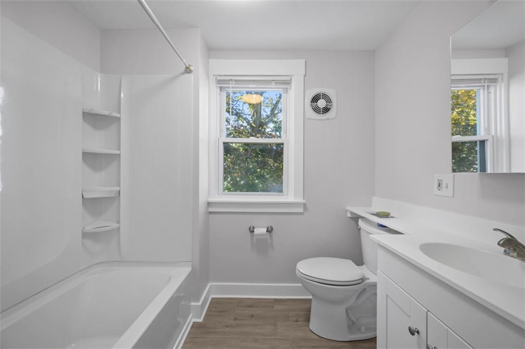 464 Franklin Street Slippery Rock, PA 16057 - Photo 35 of 45 a bathroom with a granite countertop toilet a sink and a bathtub