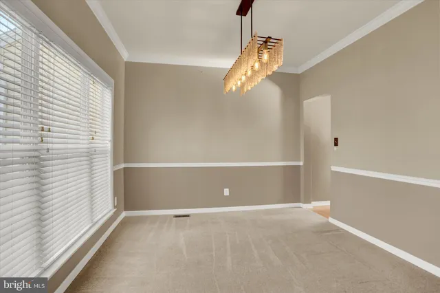 a view of a room with an empty space and a window