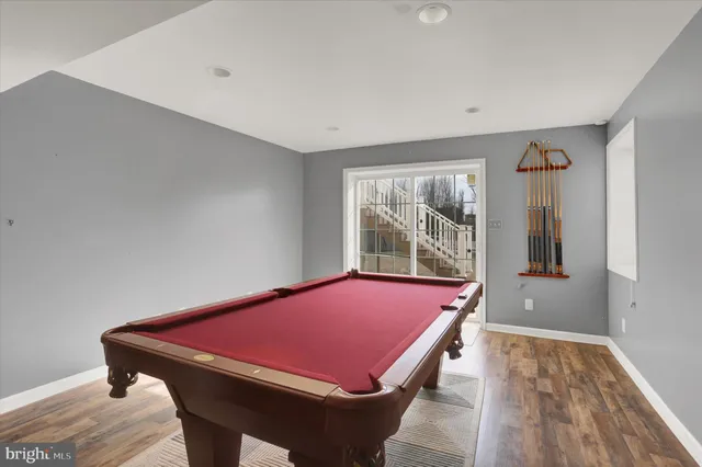 a room with pool table and a window