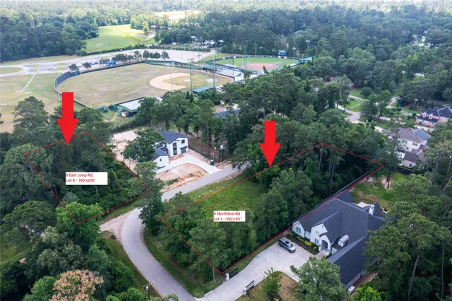 an aerial view of a house with a yard and lake view