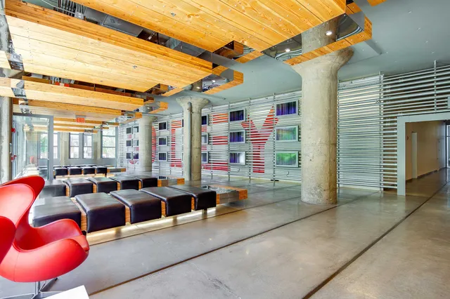 a bedroom with two beds and a large window